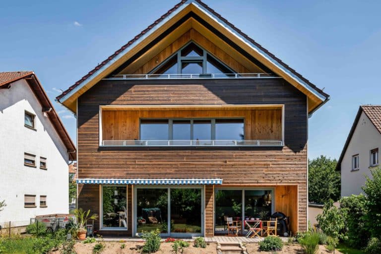 House with light brown wooden facade and pointed roof