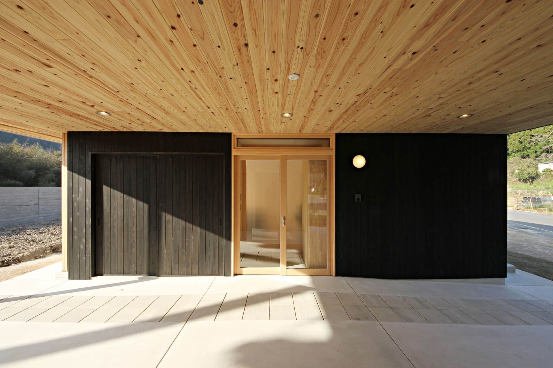 Black wooden wall facade with bright ceiling made of sugi