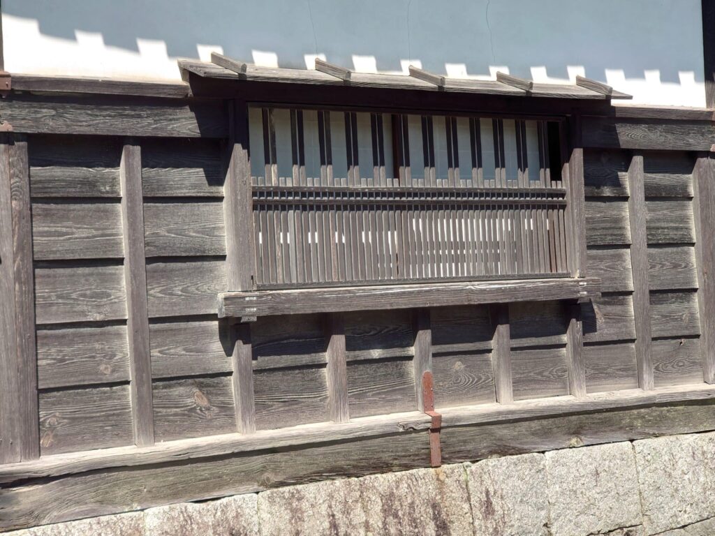 Window integrated in timber cladding of old Japanese house